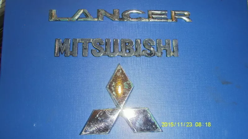 	 Эмблема Mitsubishi Lancer X оригинал б/у 2